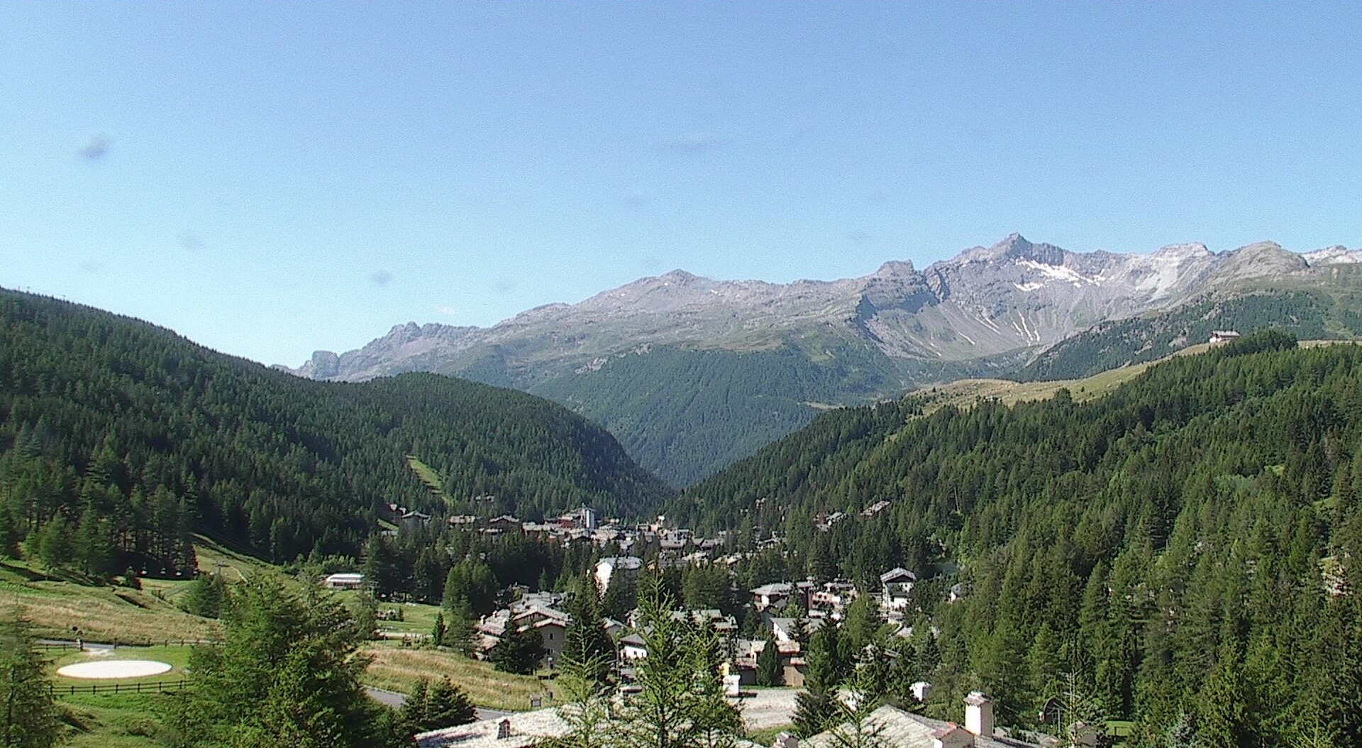 Panoramic view of the snow-covered alpine village of Madesimo at sunset